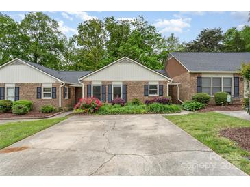 Charming brick home with a well-manicured front yard and ample parking space at 652 Camrose Ne Cir, Concord, NC 28025