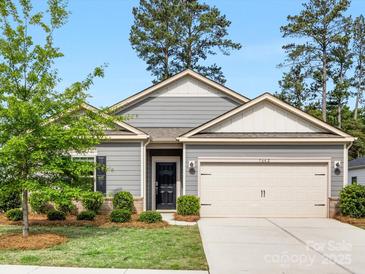 Charming single-story home with a two-car garage, landscaped front yard, and a welcoming entrance at 7642 Porrera St, Charlotte, NC 28214