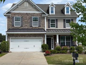 Charming two-story home with stone accents, manicured landscaping, and a two-car garage at 79044 Ridgehaven Rd, Lancaster, SC 29720
