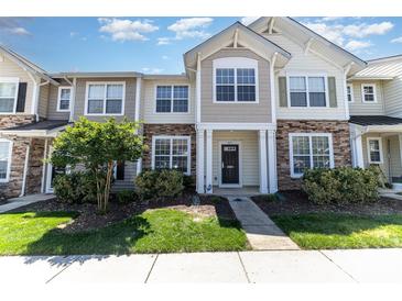 Charming townhouse showcasing a stone facade and well-manicured landscaping at 827 Gentlewinds Ct, Fort Mill, SC 29708