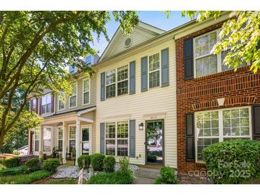Charming townhouse with blue shutters, landscaping, and a well-maintained front yard at 8814 Gerren Ct, Charlotte, NC 28217