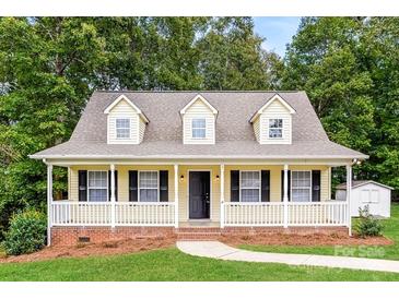 Charming yellow home featuring a welcoming front porch, black shutters and dormer windows at 1930 Manning Pl, Rock Hill, SC 29730