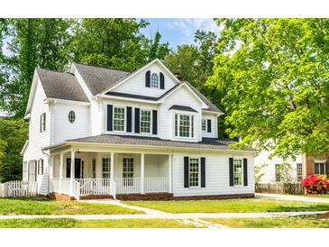 Charming two-story home with a covered front porch, black shutters, and a well-maintained lawn at 20135 Northport Dr, Cornelius, NC 28031