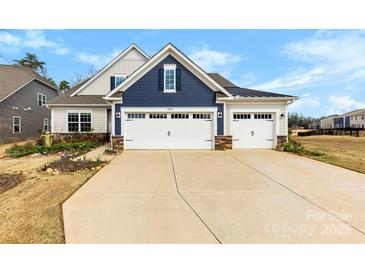 Charming two-story home featuring a two-car garage, well-manicured lawn, and beautiful landscaping at 21110 Bank Fire Ln, Huntersville, NC 28078