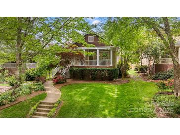 Charming home featuring a welcoming porch, landscaped yard, and beautiful curb appeal at 2306 Club Rd, Charlotte, NC 28205