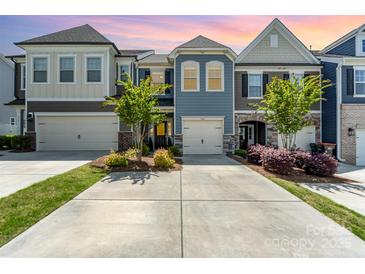 Charming townhome featuring a neatly manicured front yard and an attached garage in a desirable neighborhood at 314 Embers Ln, Clover, SC 29710