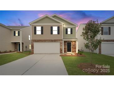 Charming two-story home with attached garage and manicured lawn at 3535 Cramer Creek Dr, Gastonia, NC 28056