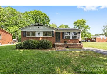 Charming single-story brick home with a well-maintained lawn and mature landscaping, exuding curb appeal at 1053 Stoneybrook Ln, Rock Hill, SC 29730