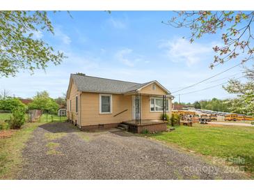 Charming single-Gathering home featuring a cozy front porch and gravel driveway at 127 Bristol Rd, Statesville, NC 28677