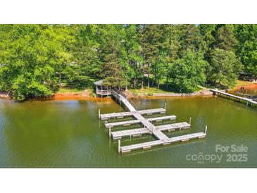 Expansive dock with gazebo offers waterfront living and access to serene lake surrounded by lush greenery at 6712 Cove Ln, Sherrills Ford, NC 28673