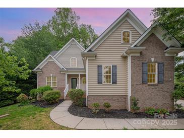 Charming home with brick and vinyl siding, landscaped front yard, and inviting entrance at 1033 Marguerite Dr, Lowell, NC 28098