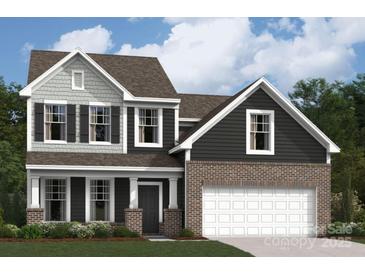 Charming two-story home featuring a two-car garage and inviting front porch at 1211 Fremont Dr, Wingate, NC 28174
