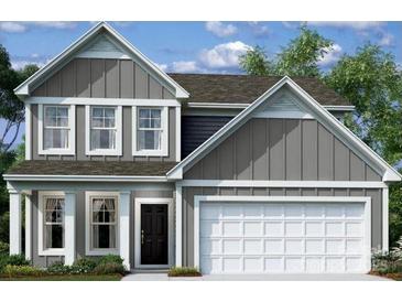 Charming two-story home with gray siding, white trim, a black front door, and an attached two-car garage at 1219 Fremont Dr, Wingate, NC 28174
