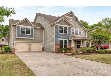 Charming two-story home showcasing a two-car garage, manicured lawn, and attractive architectural details at 140 Halifax Dr, Fort Mill, SC 29707