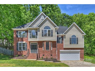 Charming two-story home with brick and vinyl siding, complemented by a well-manicured lawn and black shutters at 2544 Barrington Ct, Rock Hill, SC 29732