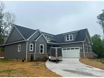 Beautiful new construction home with gray siding, brick accents, and a concrete driveway at 3733 Whitney Ne Dr, Hickory, NC 28601