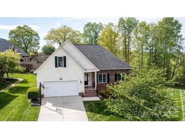 Charming home with a brick and vinyl exterior, two-car garage, and well-manicured lawn at 3837 1St Street Nw Ln, Hickory, NC 28601