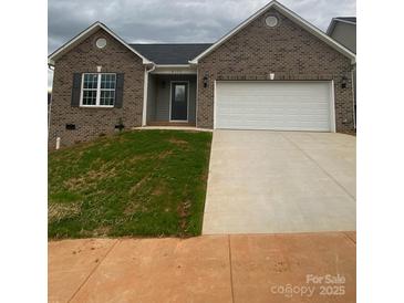 Charming brick home featuring a two-car garage and a well-manicured lawn at 4172 Saltwood Dr, Hickory, NC 28602