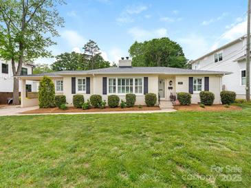 Charming home featuring a manicured lawn, brick facade, and well-maintained landscaping at 4346 Walker Rd, Charlotte, NC 28211