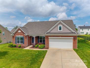 Charming brick home with a two-car garage, manicured lawn, and inviting curb appeal at 4926 Trayton Ave, Gastonia, NC 28056