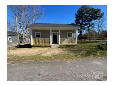Charming single-story home featuring a cozy front porch and manicured lawn at 567 5Th St, Chester, SC 29706