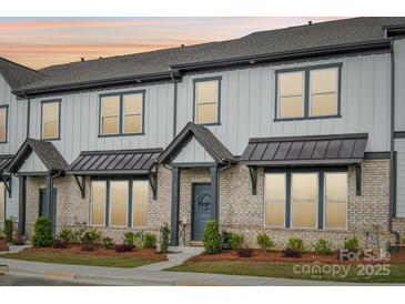 Attractive brick and vinyl townhome with covered entry and landscaped yard at 5712 Runnel Way, Charlotte, NC 28215