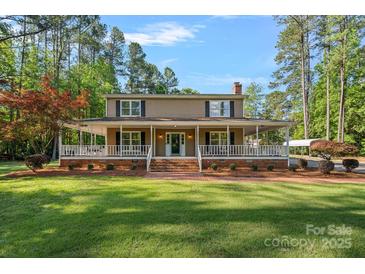 Charming two-story home with a covered porch, brick stairs and walkway, and a large landscaped front yard at 836 Meadowlark Dr, Rock Hill, SC 29732