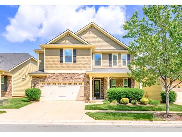 Charming two-story home featuring a stone facade, two-car garage, and manicured front lawn at 121 Martingale Ave, Mooresville, NC 28115
