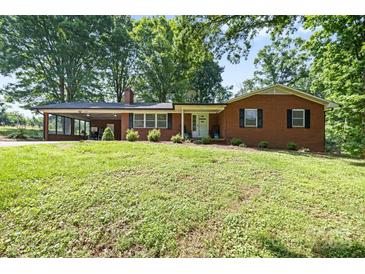 Charming brick ranch with a well-maintained lawn and a cozy, covered carport at 137 Deal Ln, Statesville, NC 28677