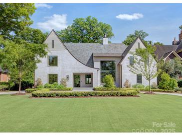 Stunning exterior view of a two-story home with manicured lawn and lush landscaping at 1919 Shoreham Dr, Charlotte, NC 28211