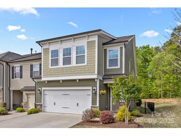 Charming two-story home with a two-car garage, landscaped yard, and inviting curb appeal at 2034 Suttonview Rd, Fort Mill, SC 29708