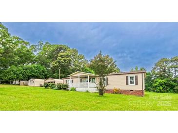 Charming single-story home with a welcoming porch and well-maintained lawn at 8140 Karriker Rd, Kannapolis, NC 28081