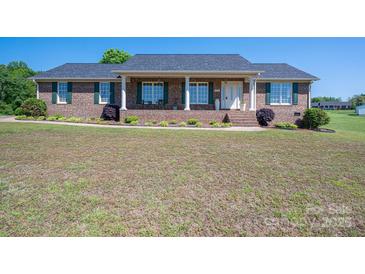 Charming brick home featuring a welcoming front porch and well-maintained landscaping at 118 Sir Gregory Dr, Shelby, NC 28152