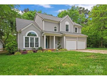 Charming two-story home featuring gray siding, well-manicured lawn, and a two-car garage at 121 Northampton Dr, Mooresville, NC 28117