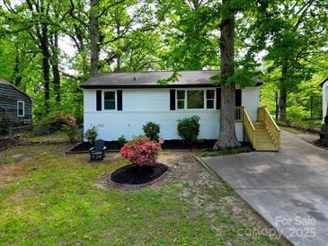 Charming home featuring a landscaped front yard and a newly constructed wooden staircase at 1750 Oak Valley Dr, Gastonia, NC 28054