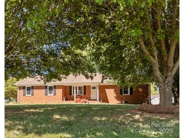 Charming single-story brick home with a well-manicured lawn and mature shade trees at 250 Log Barn Rd, Salisbury, NC 28146