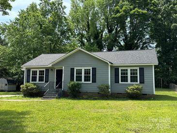 Charming one-story home with gray siding, black shutters, and a well-manicured lawn and mature trees at 5008 Delivau Dr, Charlotte, NC 28215