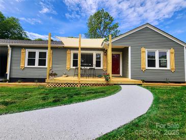 Charming one-story home with a welcoming front porch and a freshly painted walkway at 501 N Hawthorne St, Mount Holly, NC 28120