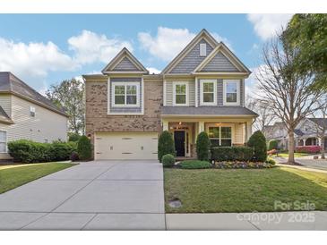 Charming two-story home with a manicured lawn and a two-car garage at 8200 Sunset Hill Rd, Waxhaw, NC 28173