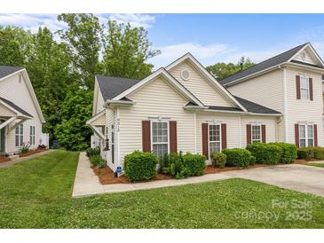 Charming home with manicured lawn, brown shutters, and a concrete driveway at 8313 Carob Tree Ln, Charlotte, NC 28215
