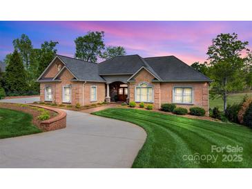 Beautiful single-story brick home with a curved driveway and well-manicured lawn at 89 Wexford Pt, Hickory, NC 28601