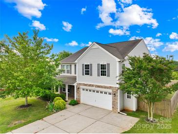 Charming two-story home with light grey siding, two-car garage, and lush green lawn at 105 Altondale Dr, Statesville, NC 28625