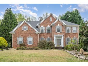 Charming brick two-story home with manicured lawn, symmetrical design and welcoming entrance at 2620 Shady Reach Ln, Charlotte, NC 28214