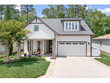 Charming home featuring a two-car garage, well-manicured lawn, and a inviting front porch at 4902 Looking Glass Trl, Denver, NC 28037