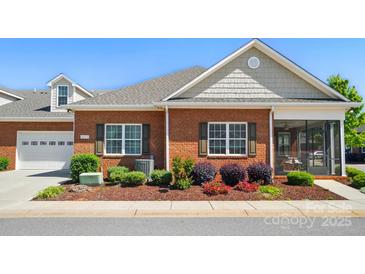 Well maintained brick home featuring manicured landscaping and a screened-in porch at 8473 Bing Cherry Dr, Denver, NC 28037