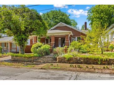 Charming brick home featuring a landscaped front yard with stone accents and a inviting front porch at 119 Wiley Ave, Salisbury, NC 28144