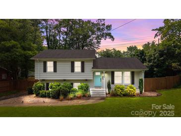 Charming split-level home with a light blue front door, beautiful landscaping, and a cozy feel at 2100 Shadyview Dr, Charlotte, NC 28210