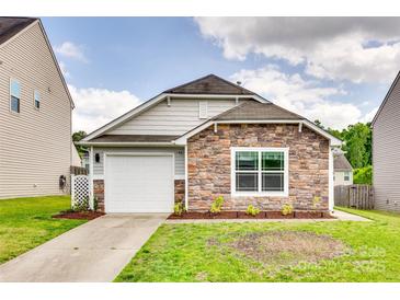 Charming single-story home with a stone facade, attached garage, and freshly landscaped front yard at 2810 Berry Creek Rd, Charlotte, NC 28214