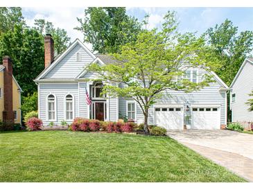 Charming two-story home featuring a well-manicured lawn, three-car garage, and inviting curb appeal at 6425 High Creek Ct, Charlotte, NC 28277