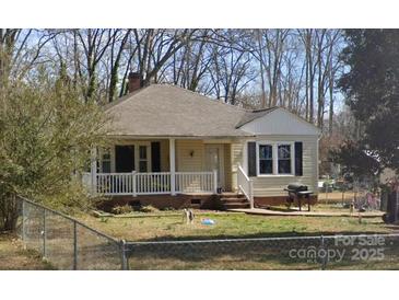 Charming single-story home with a welcoming front porch and fenced yard at 721 S Spruce St, Rock Hill, SC 29730